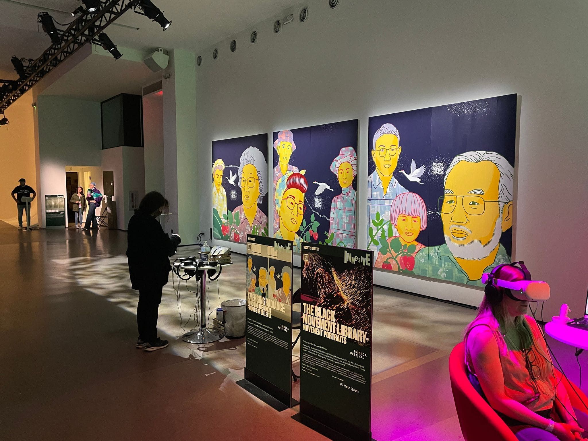 Emerging Radiance murals exhibited in a gallery with a visitor standing in front of them.