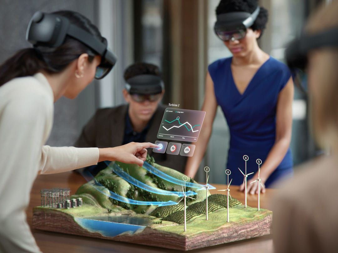 People wearing Hololens headsets and interacting with digital overlays.
