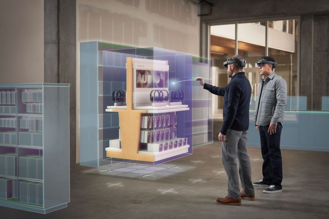 People wearing Hololens headsets and interacting with digital overlays.
