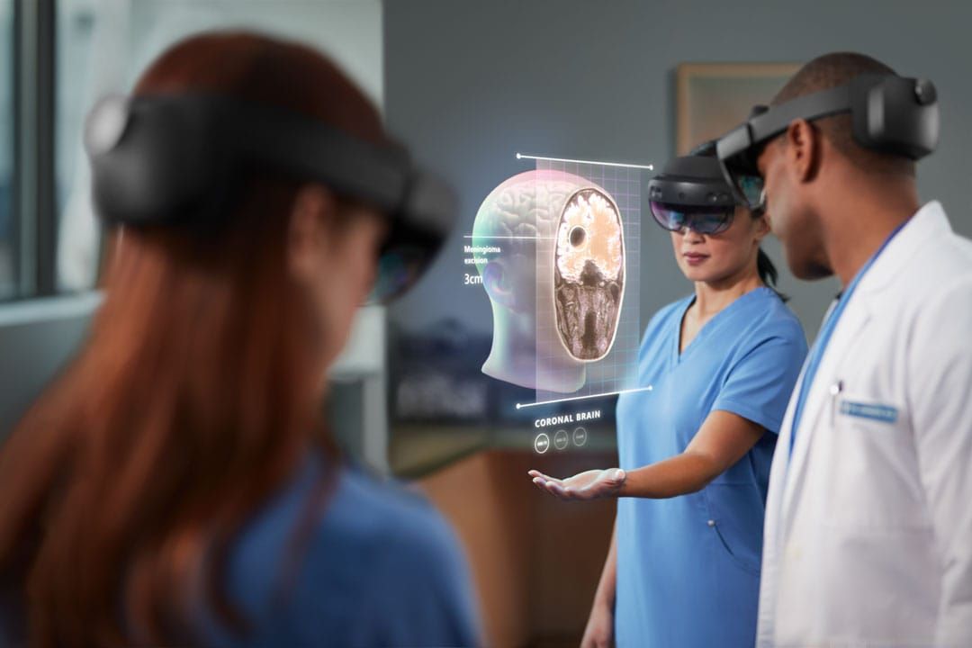Doctors wearing Hololens headsets and interacting with digital head anatomy.