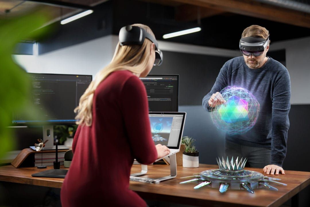 People wearing Hololens headsets and interacting with digital overlays.