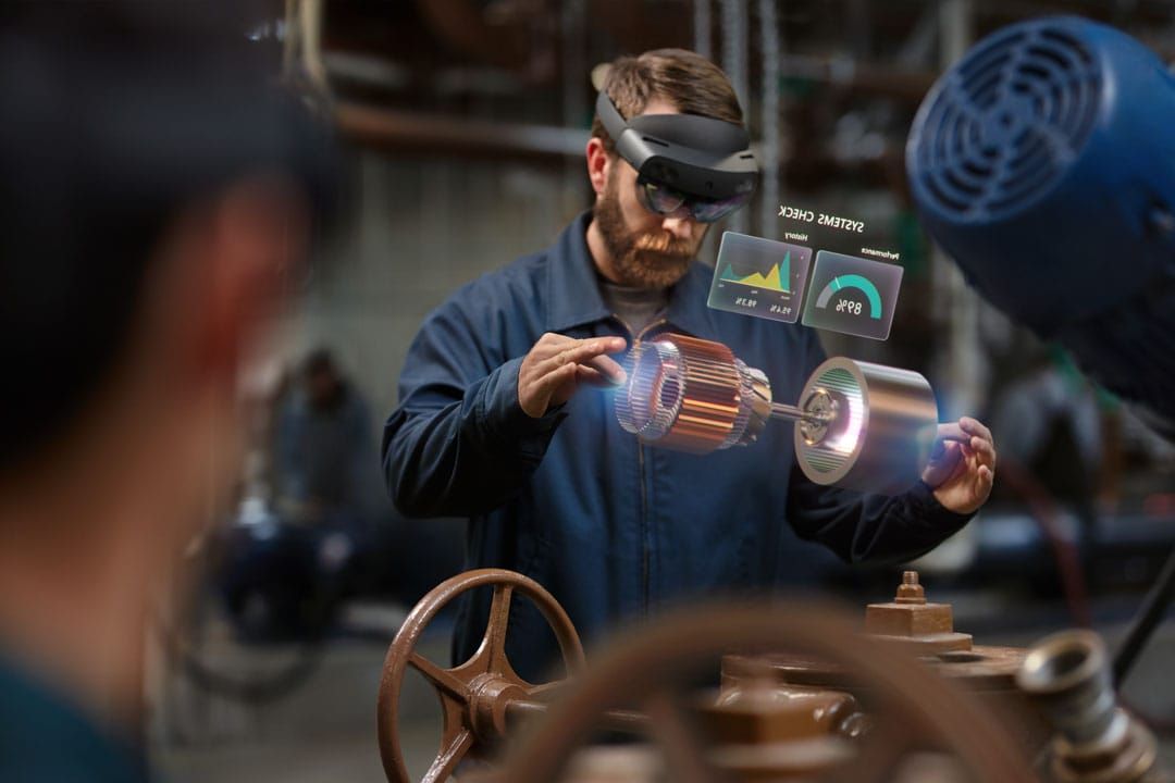 People wearing Hololens headsets and interacting with digital overlays.