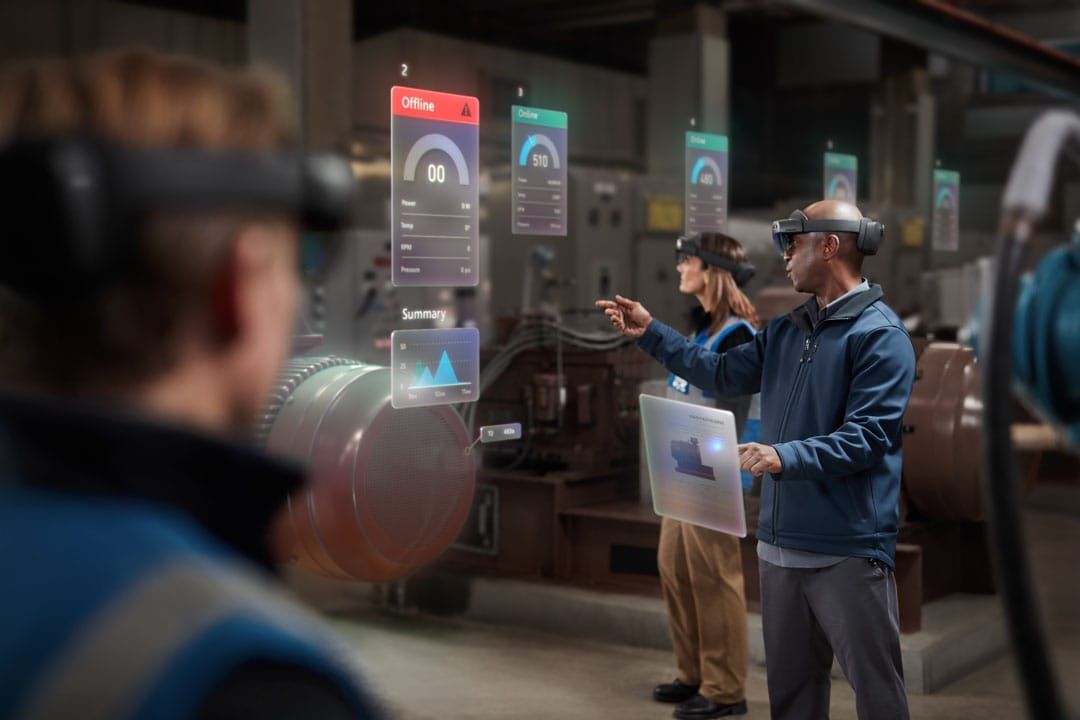 People wearing Hololens headsets and interacting with digital overlays.