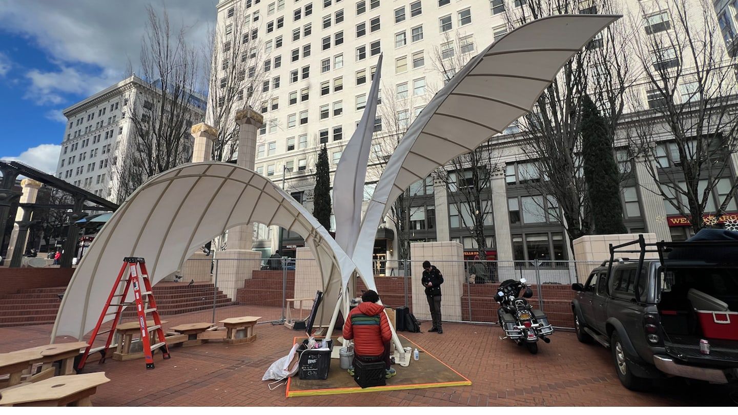 A large bird sculpture during the day.
